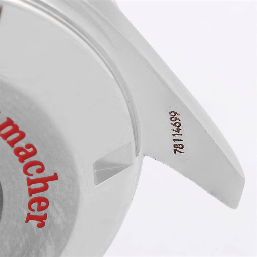 The image shows a close-up of the case back and the watch lugs of an Omega Speedmaster 3506.61.00 Men
s Stainless Steel Red Dial 3506.61.00 Men
s Stainless Steel Red Dial, featuring part of the branding and serial number.