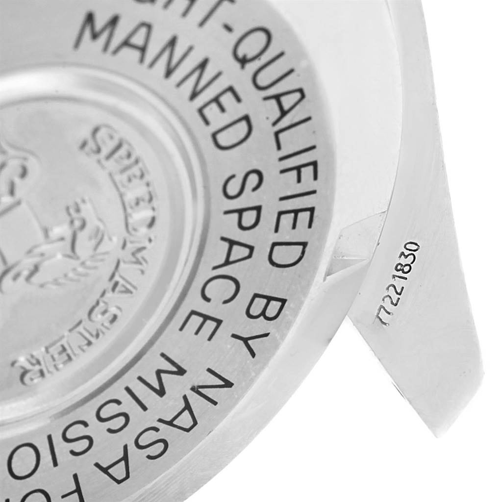 The image shows a close-up of the case back of an Omega Speedmaster 3570.50.00 Men
s Stainless Steel Black Dial 3570.50.00 Men
s Stainless Steel Black Dial watch with engraved writing and a portion of the serial number.