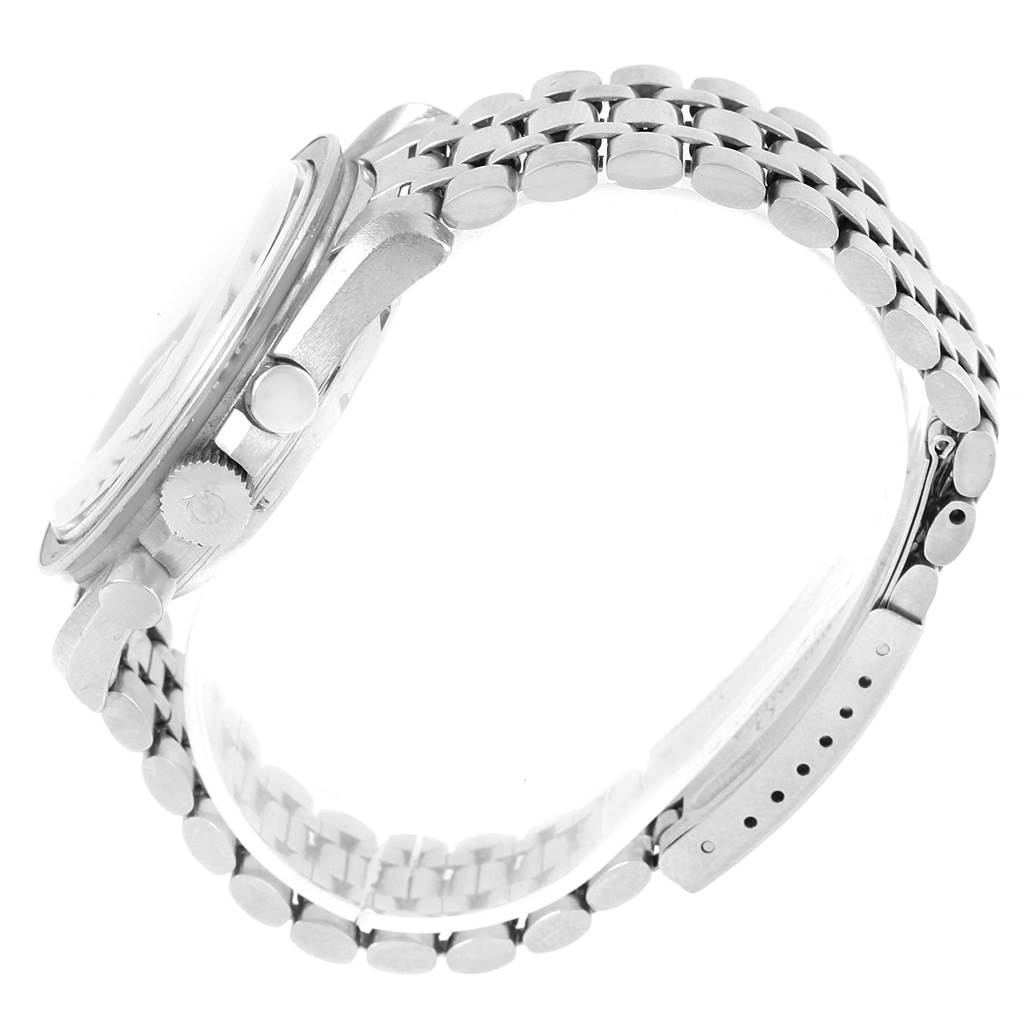 This side view of the Omega Speedmaster Men
s Stainless Steel Black Dial Men
s Stainless Steel Black Dial watch displays its crown, pushers, and metal bracelet.