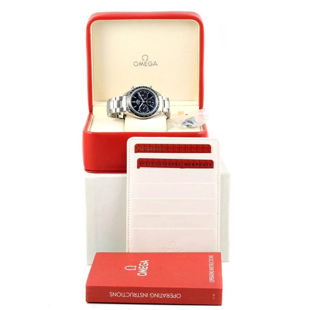 The image shows an Omega Speedmaster 326.30.40.50.01.001 Men
s Stainless Steel Black Dial 326.30.40.50.01.001 Men
s Stainless Steel Black Dial watch in its box, along with warranty cards and an instruction manual.