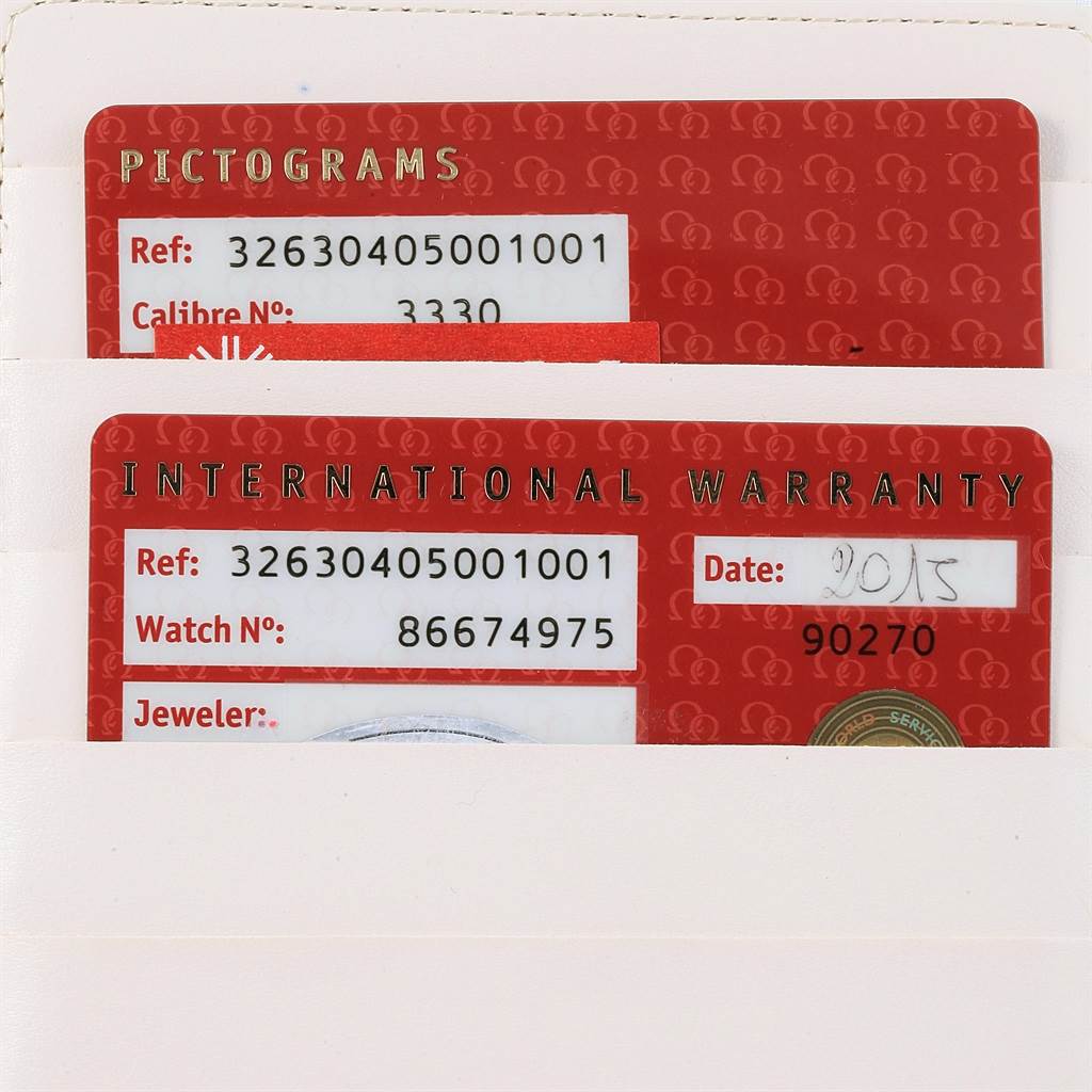 The image shows a close-up of an Omega Speedmaster 326.30.40.50.01.001 Men
s Stainless Steel Black Dial 326.30.40.50.01.001 Men
s Stainless Steel Black Dial
s International Warranty and Pictograms cards.