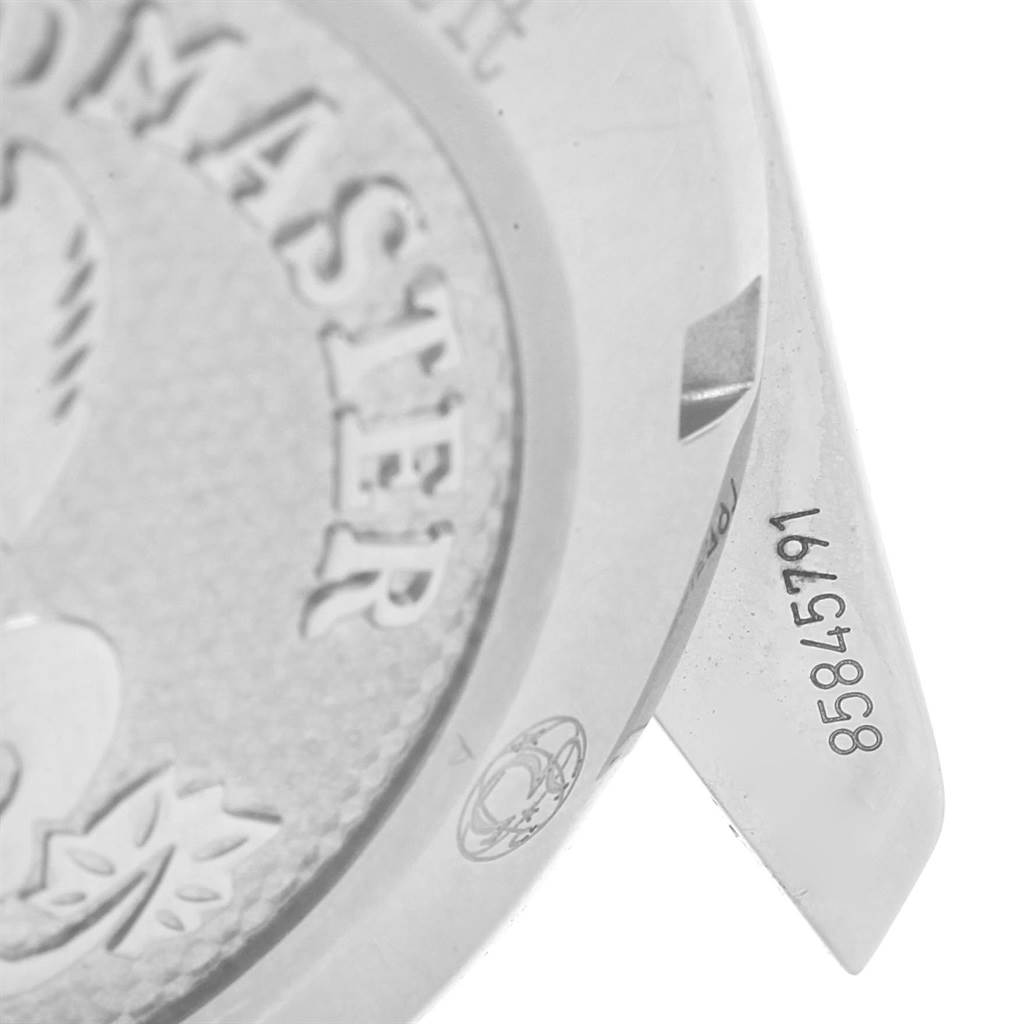 The image shows a close-up of the case back and the lugs of an Omega Speedmaster 324.30.38.40.06.001 Men
s Stainless Steel Grey Dial 324.30.38.40.06.001 Men
s Stainless Steel Grey Dial, including the serial number and part of the embossed logo.