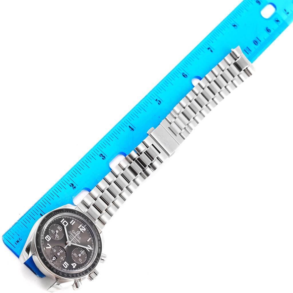 The Omega Speedmaster 324.30.38.40.06.001 Men
s Stainless Steel Grey Dial 324.30.38.40.06.001 Men
s Stainless Steel Grey Dial watch is shown from a top-down angle, featuring the face, bracelet, and a ruler for size reference.