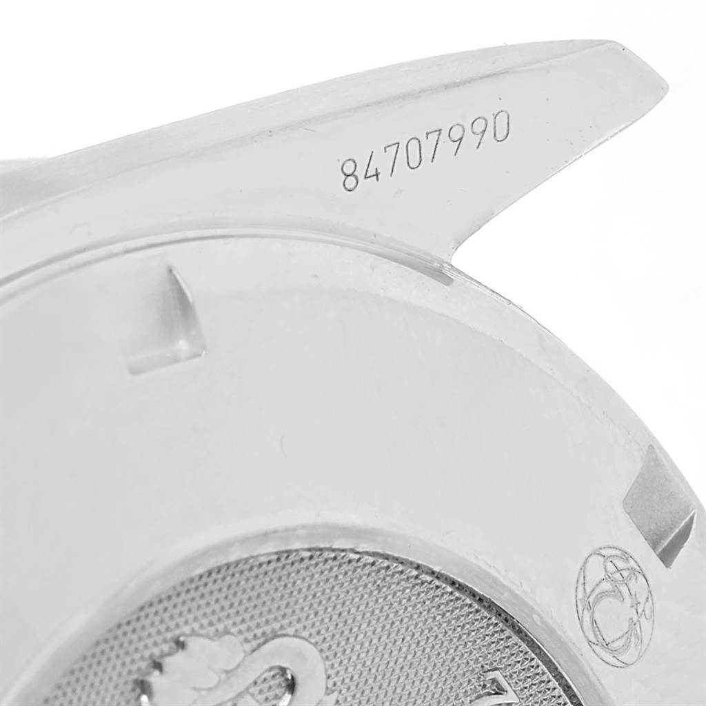 This image shows the serial number and a partial view of the case back of an Omega Speedmaster 3211.30.00 Men
s Stainless Steel Silver Dial 3211.30.00 Men
s Stainless Steel Silver Dial watch.