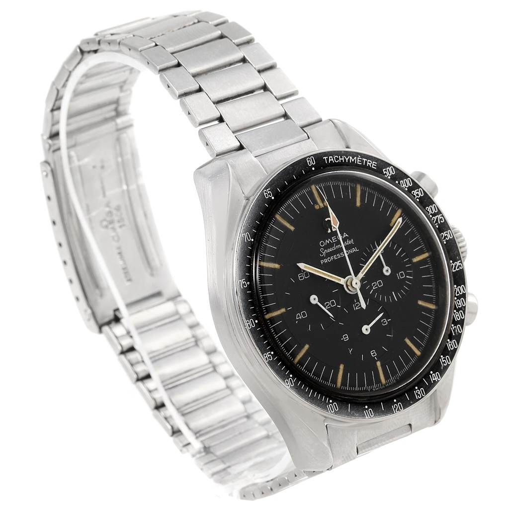 The image shows an angled view of an Omega Speedmaster 105.012-64 Men's Stainless Steel Black Dial 105.012-64 Men's Stainless Steel Black Dial watch, highlighting its face, bezel, and metal bracelet.