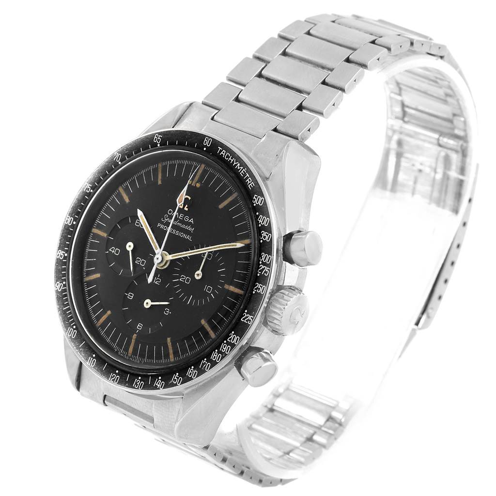 The image shows an angled view of an Omega Speedmaster 105.012-64 Men's Stainless Steel Black Dial 105.012-64 Men's Stainless Steel Black Dial watch, emphasizing the dial, bezel, crown, and bracelet.