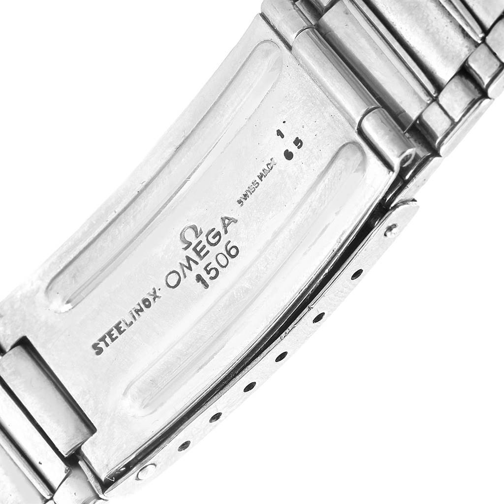 This image shows a close-up of the clasp and part of the bracelet of an Omega Speedmaster 105.012-64 Men's Stainless Steel Black Dial 105.012-64 Men's Stainless Steel Black Dial watch, model number 1506.