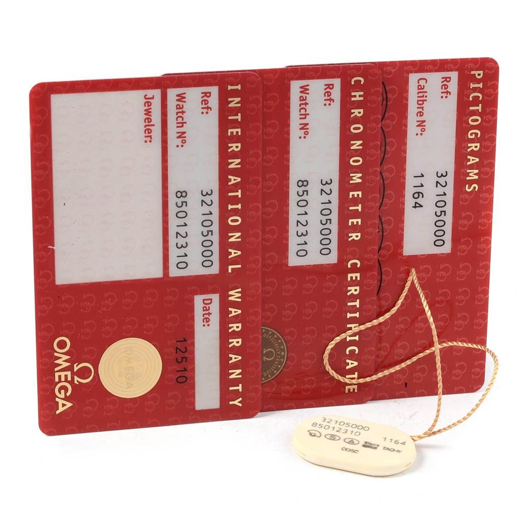 The image shows warranty cards and a tag for the Omega Speedmaster 3210.50.00 Men
s Stainless Steel Black Dial 3210.50.00 Men
s Stainless Steel Black Dial watch, viewed from above.