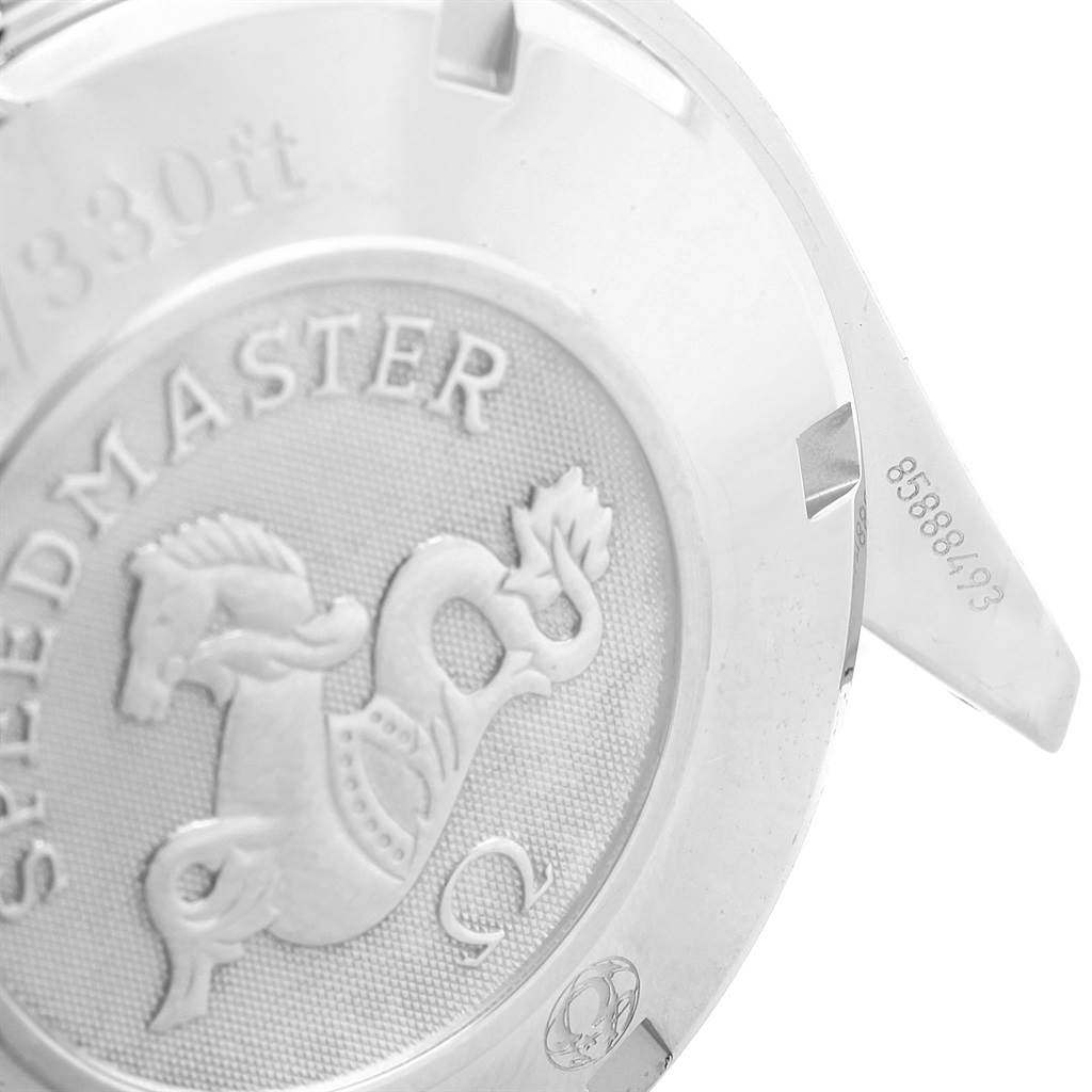 This image shows the back case of an Omega Speedmaster 3221.30.00 Men's Stainless Steel Silver Dial 3221.30.00 Men's Stainless Steel Silver Dial watch at an angled view, highlighting the engraved logo and text.