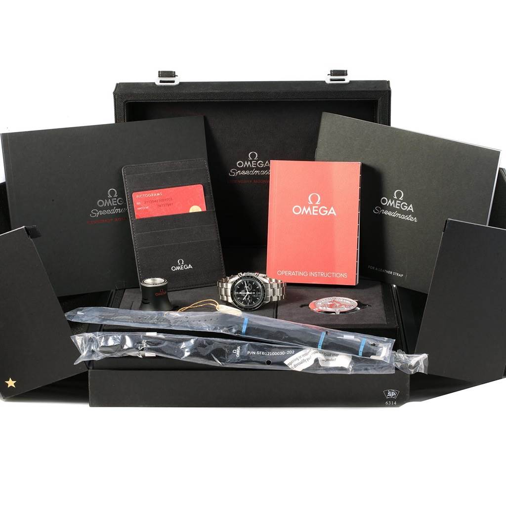 The image shows an Omega Speedmaster 311.30.42.30.01.005 Men
s Stainless Steel Black Dial 311.30.42.30.01.005 Men
s Stainless Steel Black Dial watch and accessories, including a case, manual, cards, and additional straps.