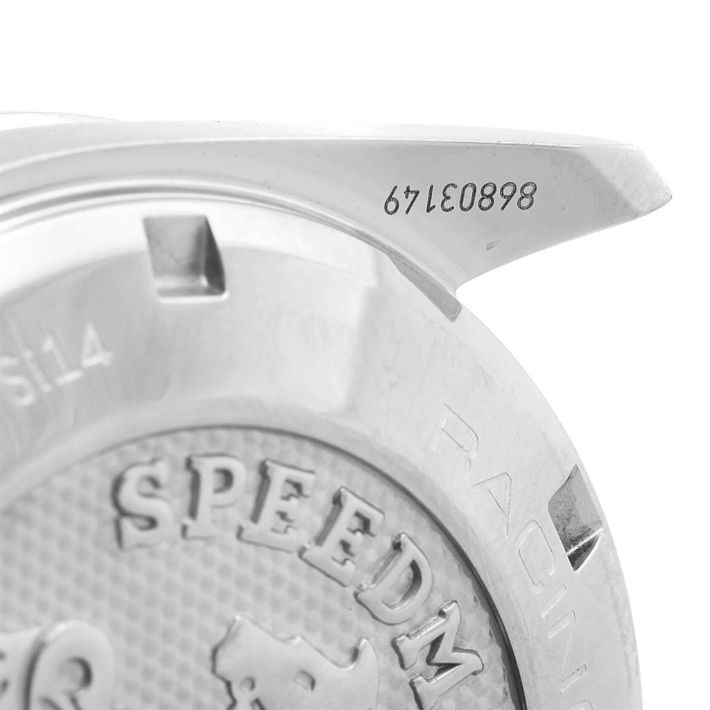 The image shows a close-up of the case back and lug of the Omega Speedmaster 326.30.40.50.06.001 Men
s Stainless Steel Grey Dial 326.30.40.50.06.001 Men
s Stainless Steel Grey Dial watch, displaying part of the logo and engraved serial number.