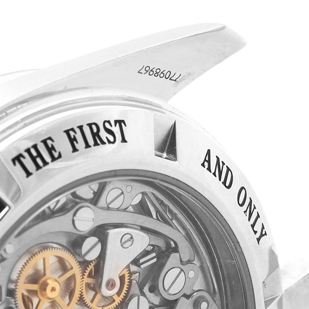 The image captures a macro view of the Omega Speedmaster 3573.50.00 Men
s Stainless Steel Black Dial 3573.50.00 Men
s Stainless Steel Black Dial
s skeleton case back and part of the lug with an engraved serial number.