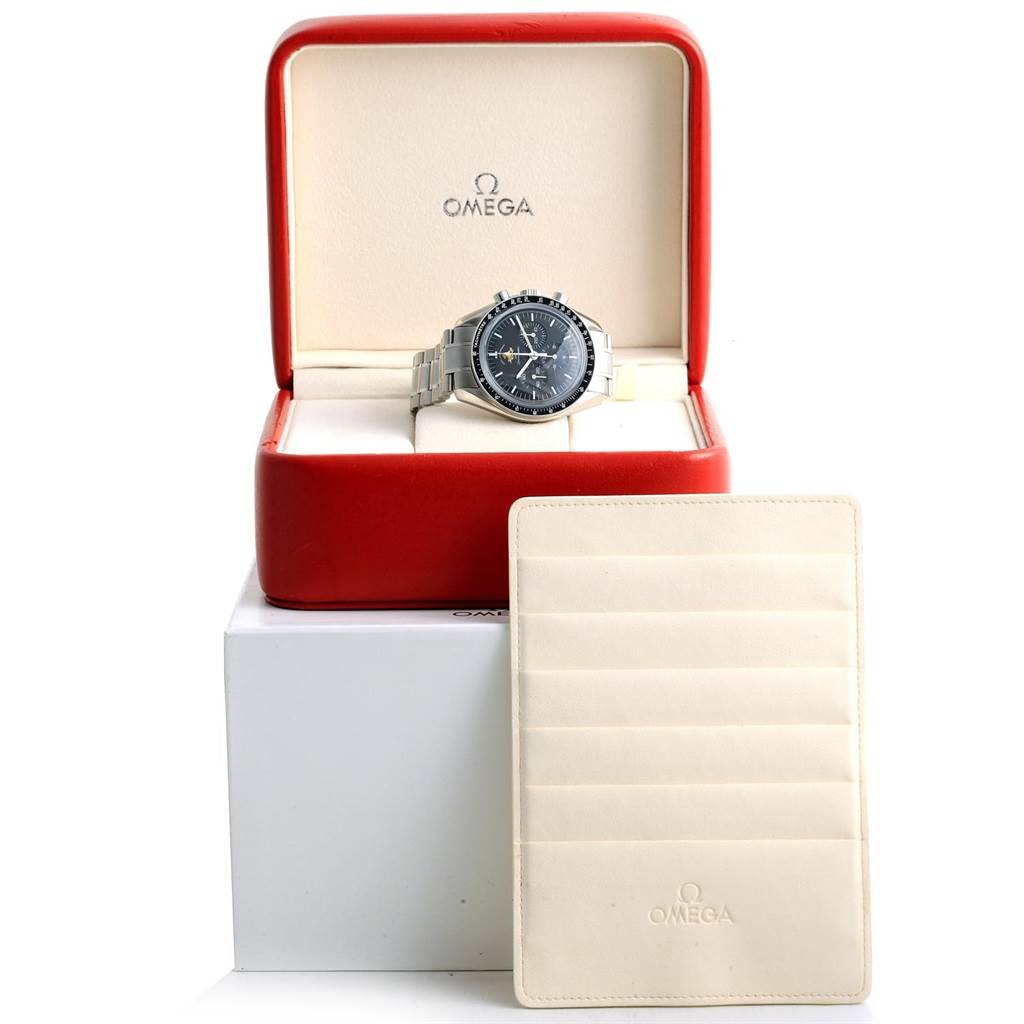 An Omega Speedmaster 311.30.42.30.01.001 Men
s Stainless Steel Black Dial 311.30.42.30.01.001 Men
s Stainless Steel Black Dial watch is displayed front-facing in an open red box with a white card holder beside it.