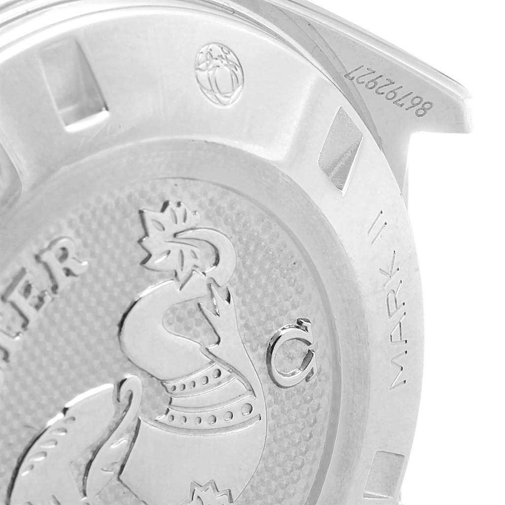 This image shows the case back of an Omega Speedmaster 327.10.43.50.06.001 Men
s Stainless Steel Grey Dial 327.10.43.50.06.001 Men
s Stainless Steel Grey Dial Mark II watch, featuring an emblem and part of the serial number.