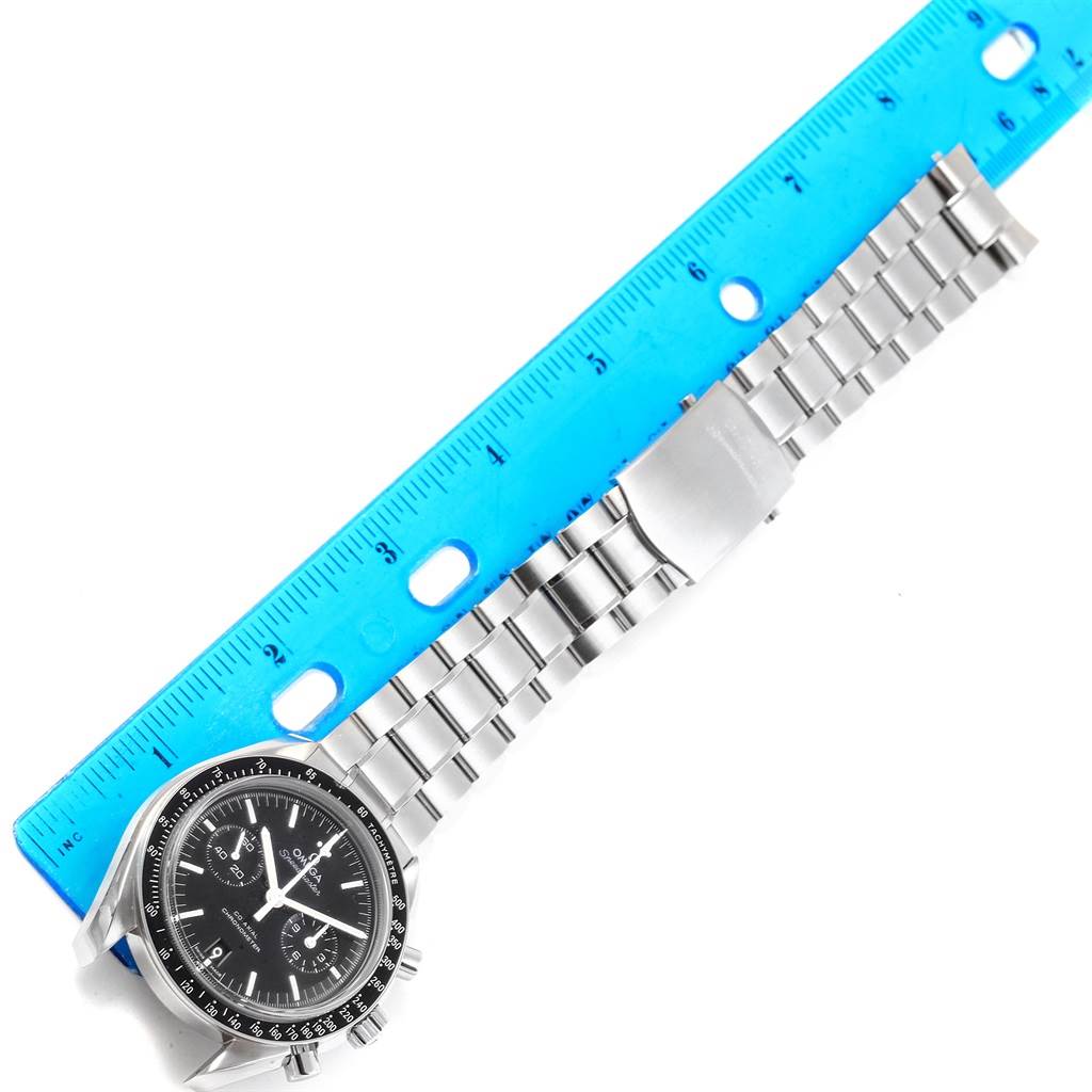 This Omega Speedmaster 311.30.44.51.01.002 Men
s Stainless Steel Black Dial 311.30.44.51.01.002 Men
s Stainless Steel Black Dial watch is shown from a top-down angle alongside a blue ruler measuring its steel bracelet.