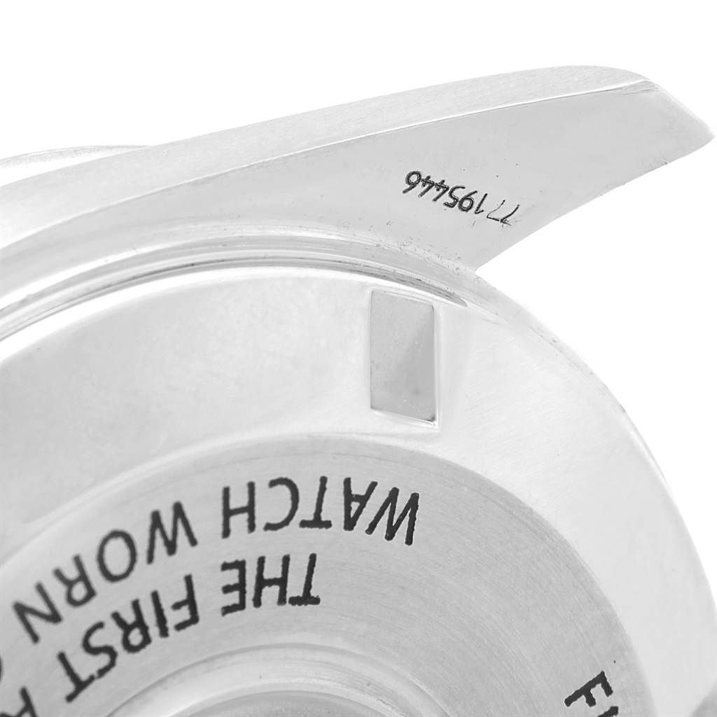 The image shows a close-up of the Omega Speedmaster 311.30.42.30.01.001 Men
s Stainless Steel Black Dial 311.30.42.30.01.001 Men
s Stainless Steel Black Dial
s engraved caseback, focusing on a partial inscription and lug.