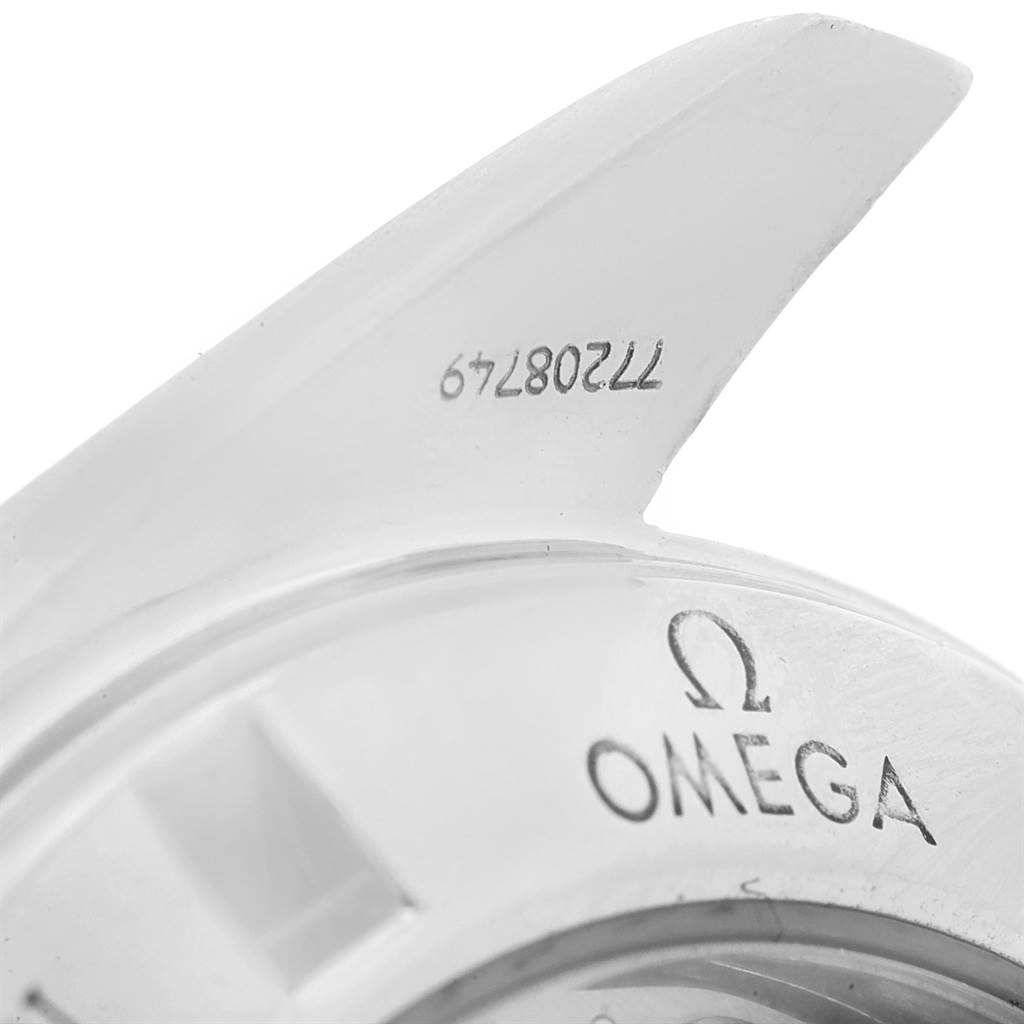 This close-up image shows a part of the bezel or case back of an Omega Speedmaster 3573.50.00 Men
s Stainless Steel Black Dial 3573.50.00 Men
s Stainless Steel Black Dial watch.