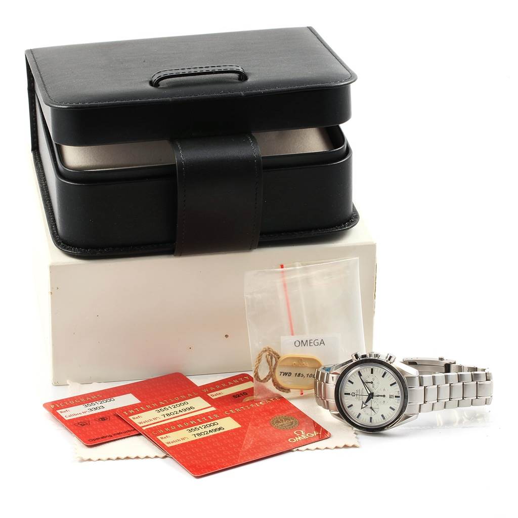 The Omega Speedmaster 3551.20.00 Men
s Stainless Steel White Dial 3551.20.00 Men
s Stainless Steel White Dial watch is shown with its black box, warranty cards, and additional accessories at an angled view from the front.