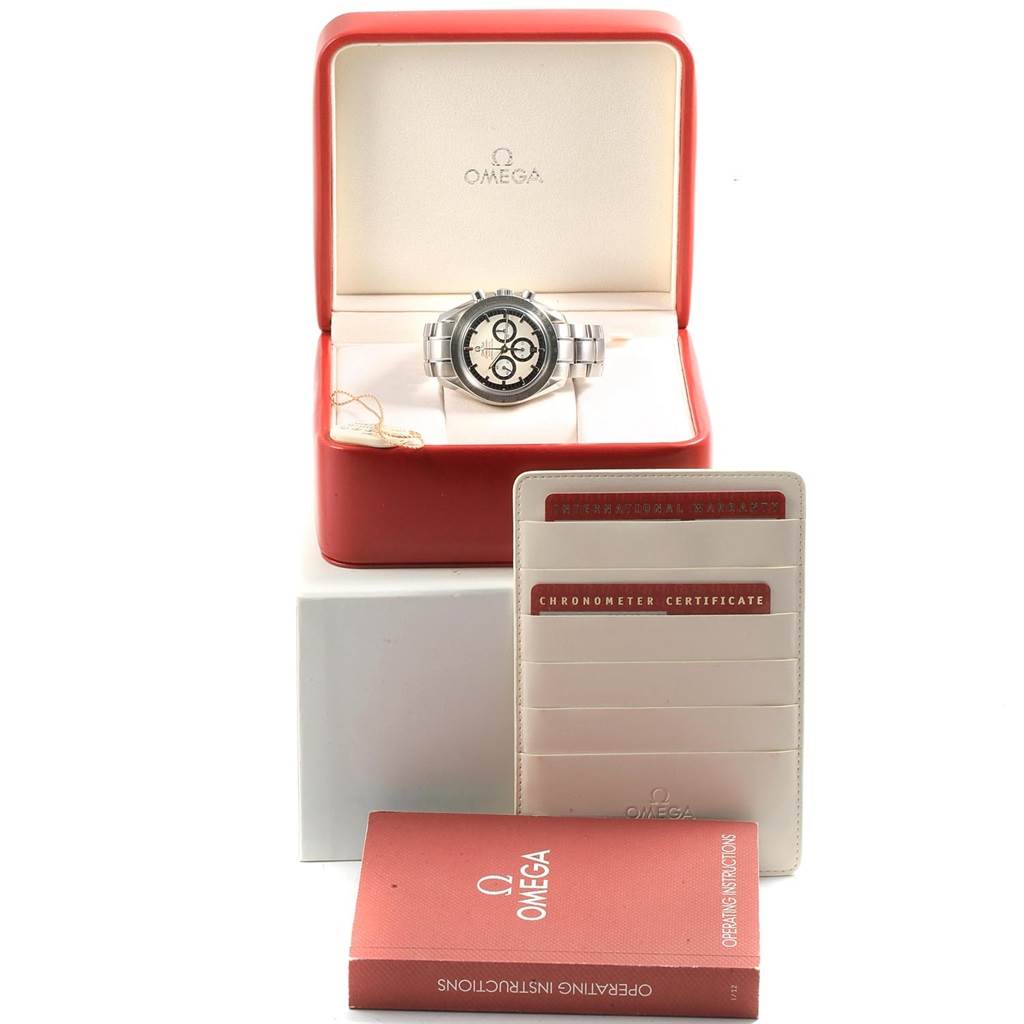 The Omega Speedmaster 3506.31.00 Men's Stainless Steel Silver Dial 3506.31.00 Men's Stainless Steel Silver Dial watch is shown from the front in its box, with accompanying booklets and certificates also in the image.