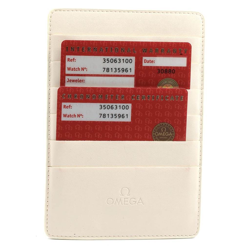 The image shows an Omega Speedmaster 3506.31.00 Men's Stainless Steel Silver Dial 3506.31.00 Men's Stainless Steel Silver Dial warranty and chronometer certificate cards in a white leather holder.