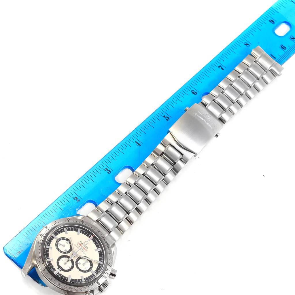 The Omega Speedmaster 3506.31.00 Men's Stainless Steel Silver Dial 3506.31.00 Men's Stainless Steel Silver Dial watch is shown laid flat next to a ruler, displaying its face, bracelet, and clasp.