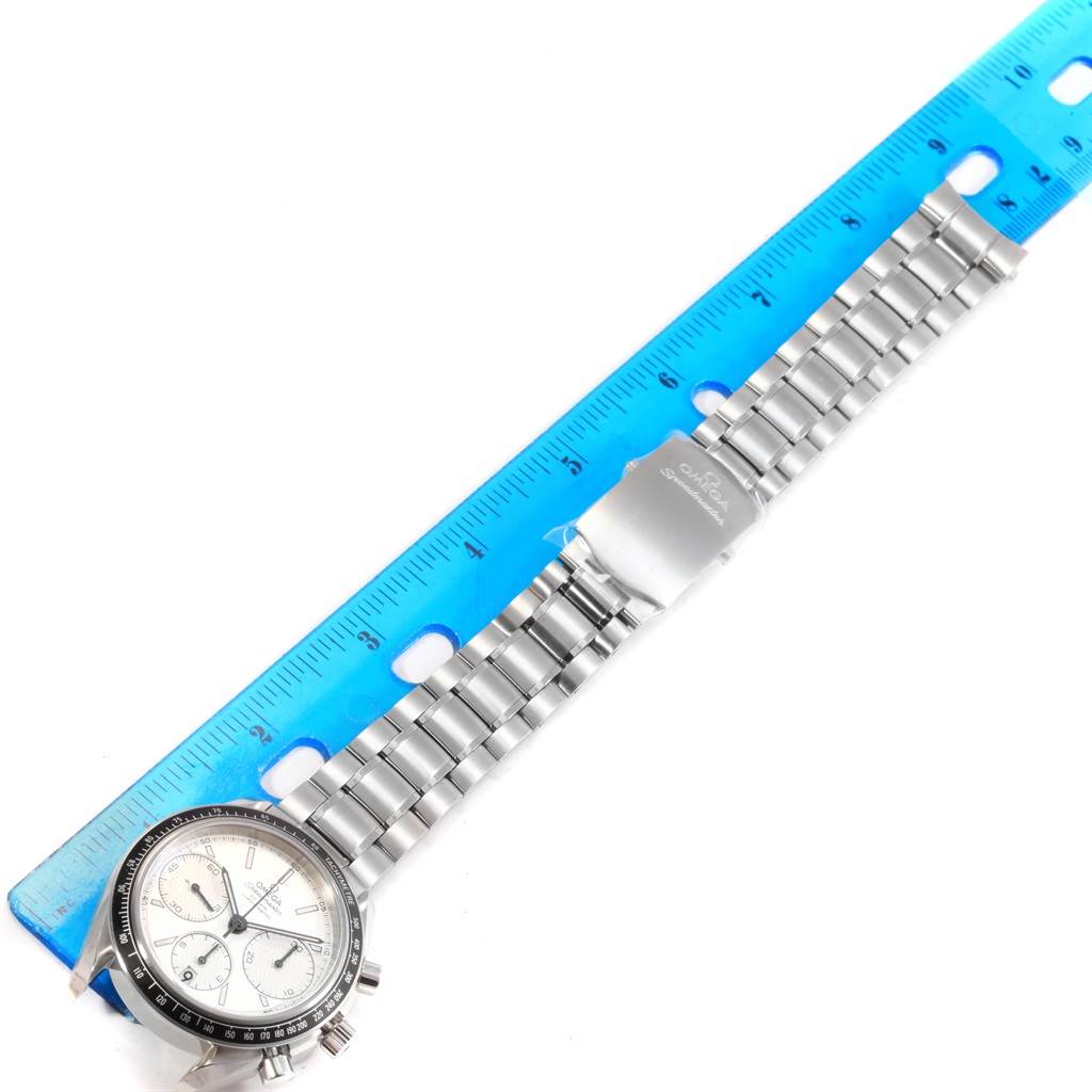 The image shows a top-down view of an Omega Speedmaster 326.30.40.50.02.001 Men
s Stainless Steel Silver Dial 326.30.40.50.02.001 Men
s Stainless Steel Silver Dial watch, including its face and metal bracelet beside a blue ruler for scale.