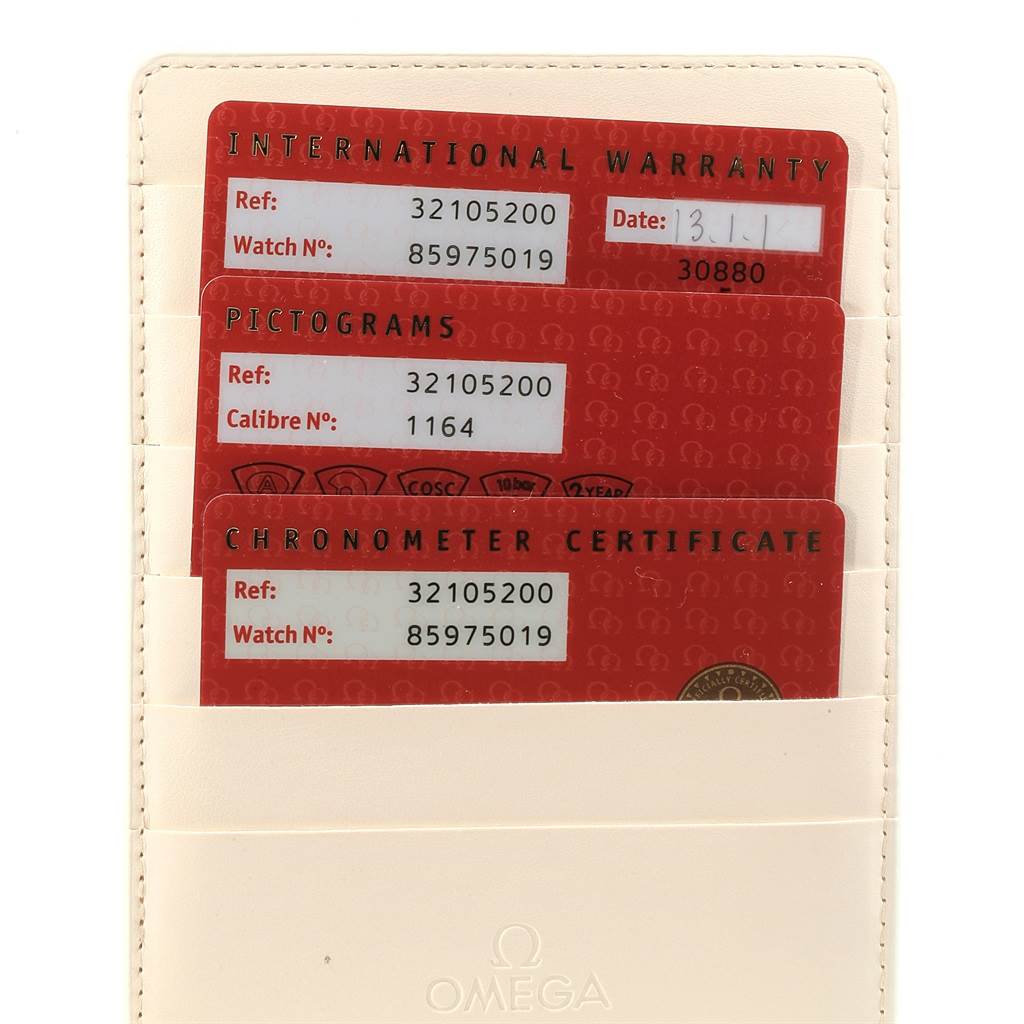 This image shows three warranty and certification cards for the Omega Speedmaster 3210.52.00 Men
s Stainless Steel Black Dial 3210.52.00 Men
s Stainless Steel Black Dial model in a beige cardholder.