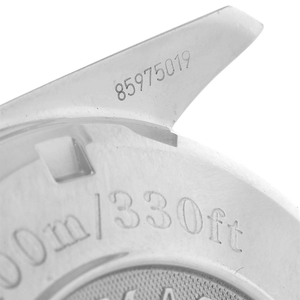 A close-up of the case back and lug of an Omega Speedmaster 3210.52.00 Men
s Stainless Steel Black Dial 3210.52.00 Men
s Stainless Steel Black Dial, showing depth rating and serial number.