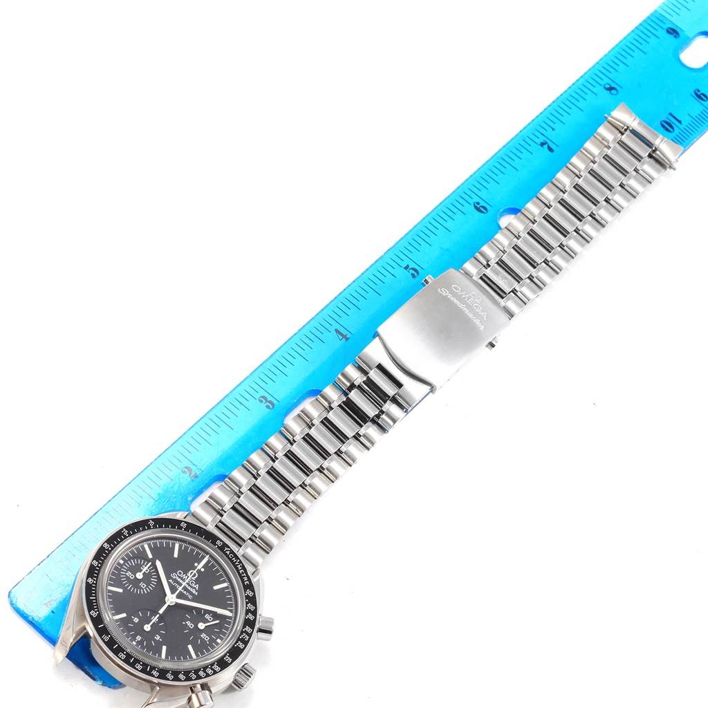 The image shows an Omega Speedmaster 3539.50.00 Men
s Stainless Steel Black Dial 3539.50.00 Men
s Stainless Steel Black Dial watch laid flat with a ruler, displaying its face, bracelet, and clasp.