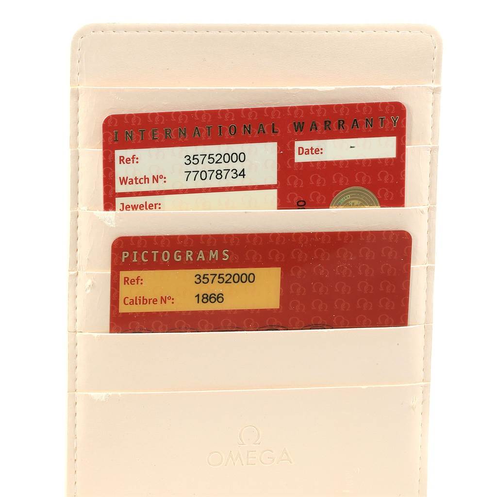 The image shows two Omega Speedmaster 3575.20.00 Men
s Stainless Steel White Dial 3575.20.00 Men
s Stainless Steel White Dial warranty and pictogram cards in a cream card holder.