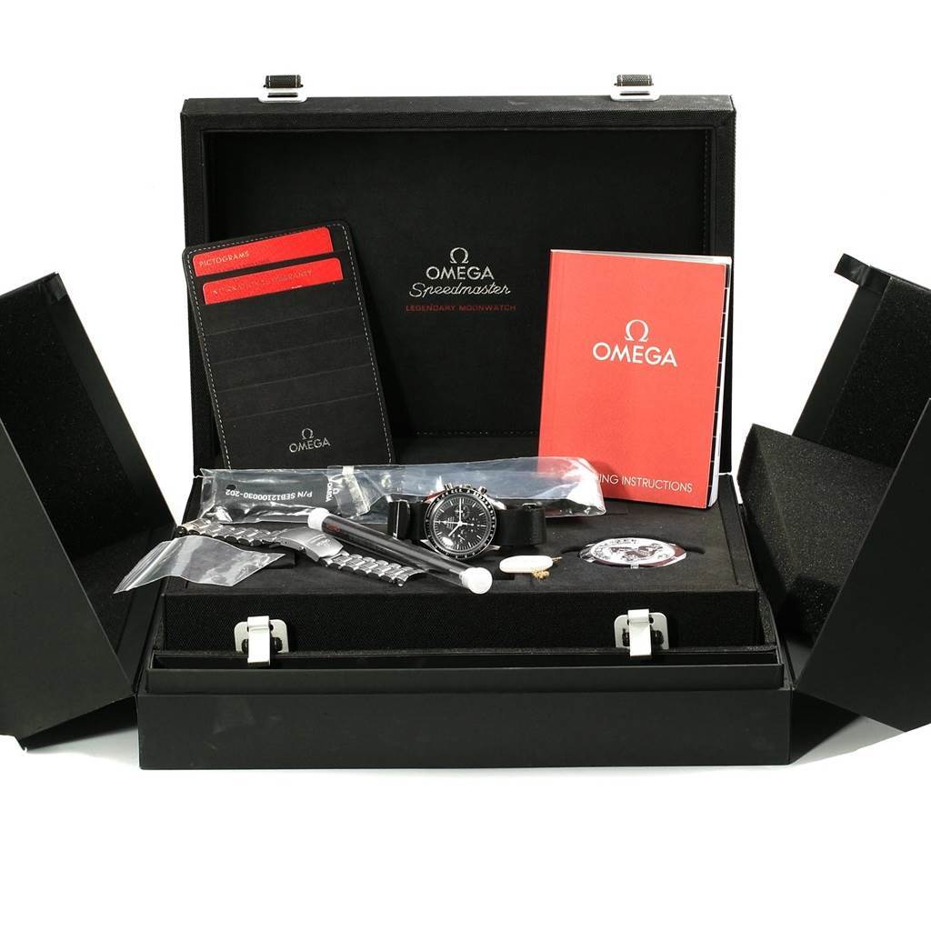 The image shows the Omega Speedmaster 311.30.42.30.01.005 Men
s Stainless Steel Black Dial 311.30.42.30.01.005 Men
s Stainless Steel Black Dial watch, its accessories, and documentation from a front angle inside its case.