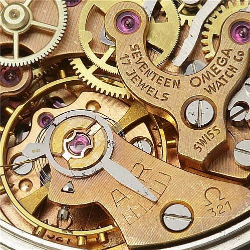 Close-up view of the movement mechanism in an Omega Speedmaster Men
s Stainless Steel Black Dial Men
s Stainless Steel Black Dial, showing gears, jewels, and the "Omega Watch Co" inscription.