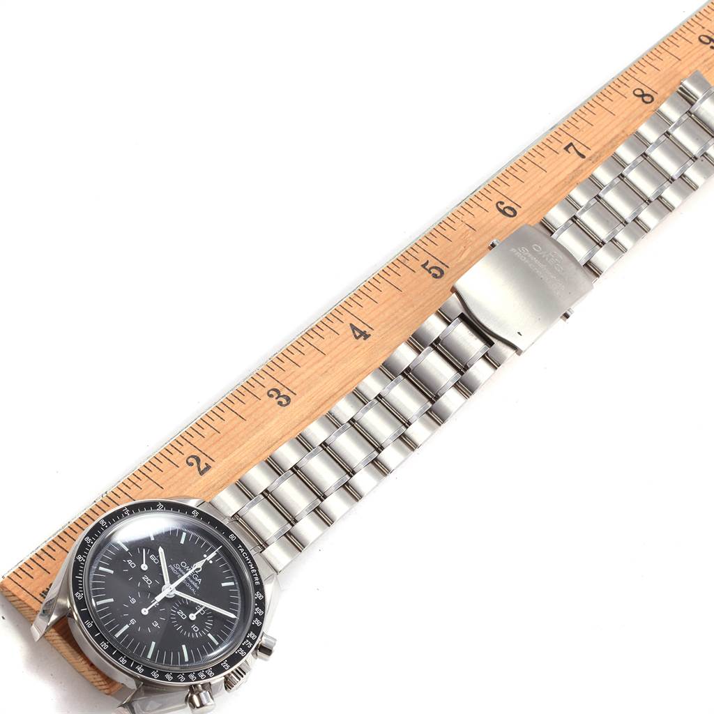 The Omega Speedmaster 311.30.42.30.01.005 Men
s Stainless Steel Black Dial 311.30.42.30.01.005 Men
s Stainless Steel Black Dial watch is shown from a top-down angle, highlighting the bezel, dial, and metal bracelet with a ruler.