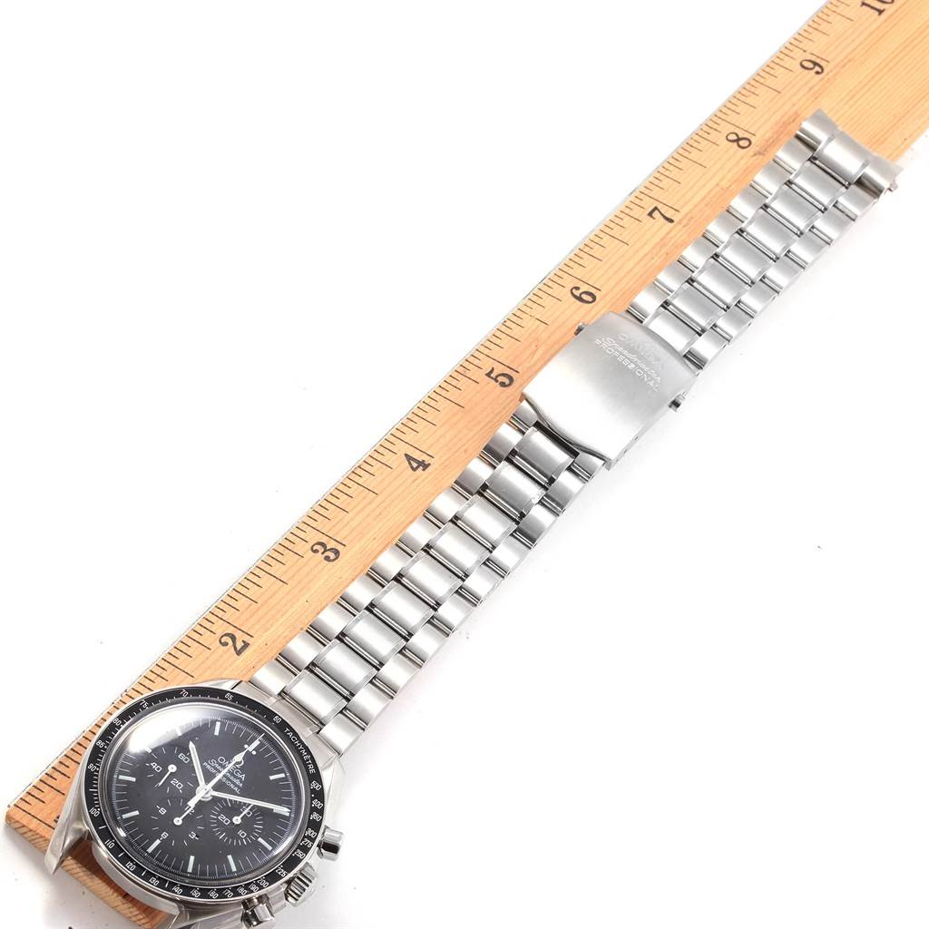 The Omega Speedmaster 3570.50.00 Men
s Stainless Steel Black Dial 3570.50.00 Men
s Stainless Steel Black Dial watch is shown laid flat with its full bracelet and clasp visible, next to a wooden ruler for scale.