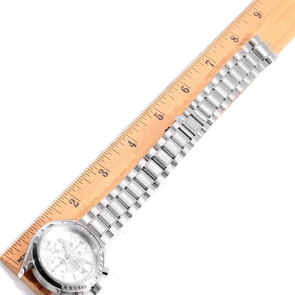 This Omega Speedmaster 3513.30.00 Men's Stainless Steel Silver Dial 3513.30.00 Men's Stainless Steel Silver Dial watch is shown from a top view, displaying its face, dial, and metal bracelet beside a ruler for measurement.