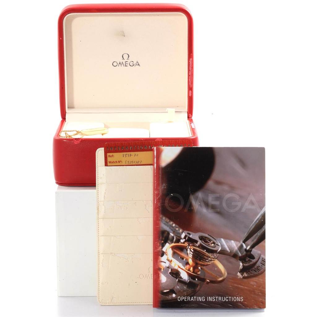 This image shows an Omega Speedmaster 3513.30.00 Men's Stainless Steel Silver Dial 3513.30.00 Men's Stainless Steel Silver Dial's box, operating instructions, and paperwork, viewed from the front.