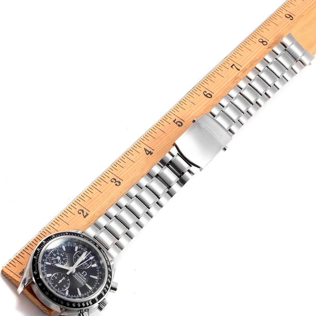 The Omega Speedmaster 3220.50.00 Men
s Stainless Steel Black Dial 3220.50.00 Men
s Stainless Steel Black Dial watch is shown from a top-down angle, aligned with a ruler to measure its metal strap length.
