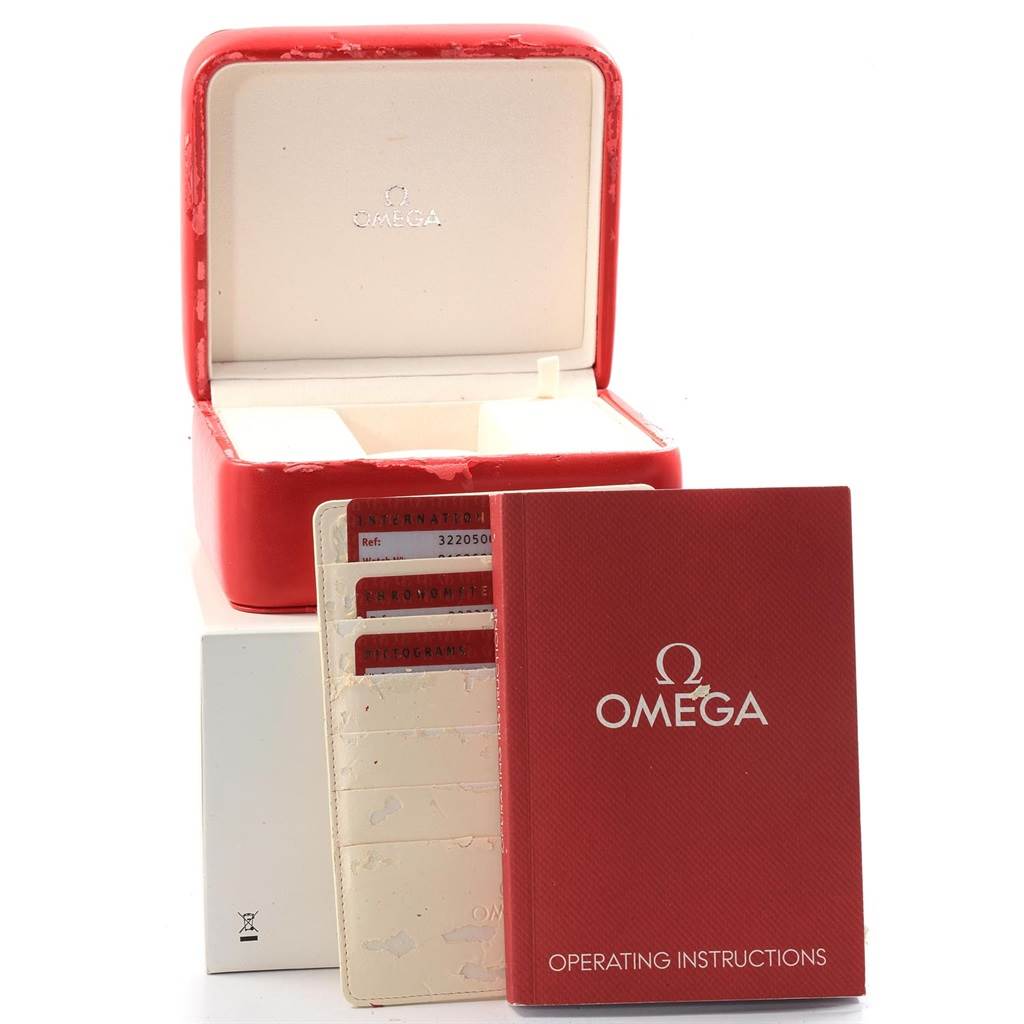 The image shows an Omega Speedmaster 3220.50.00 Men
s Stainless Steel Black Dial 3220.50.00 Men
s Stainless Steel Black Dial watch box, instruction manual, and warranty cards from a front angle.