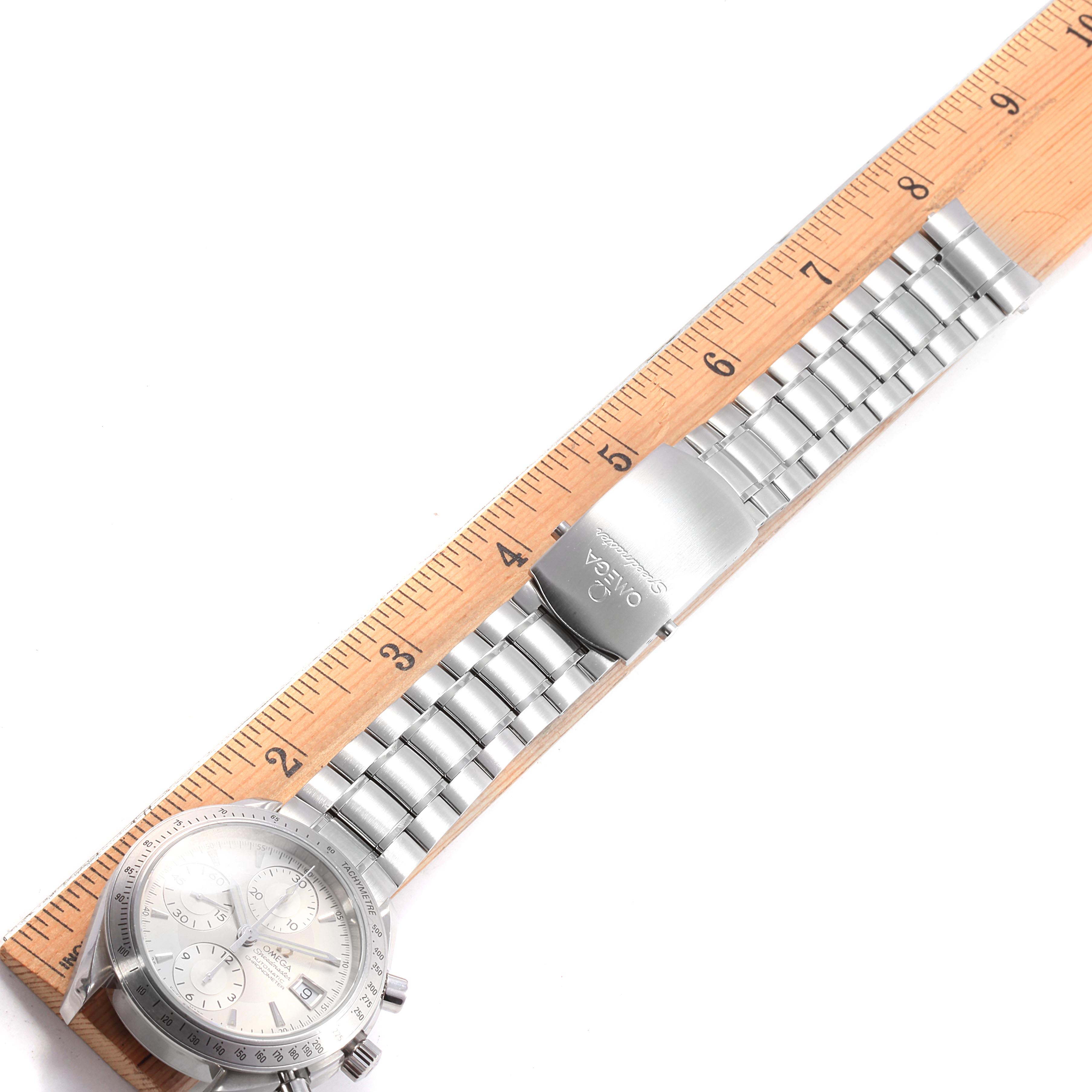 The Omega Speedmaster 3211.30.00 Men
s Stainless Steel Silver Dial 3211.30.00 Men
s Stainless Steel Silver Dial watch is shown from an overhead angle, highlighting its silver band and clasp, measured with a ruler.