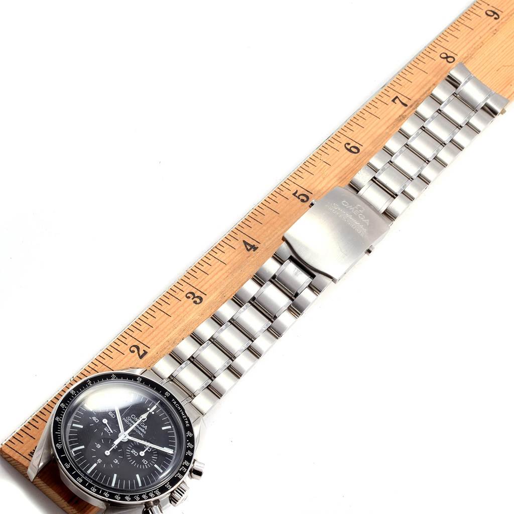 The Omega Speedmaster 311.30.42.30.01.005 Men
s Stainless Steel Black Dial 311.30.42.30.01.005 Men
s Stainless Steel Black Dial watch is shown from a top-down angle, displaying its face, bezel, and stainless steel bracelet with a ruler for scale.