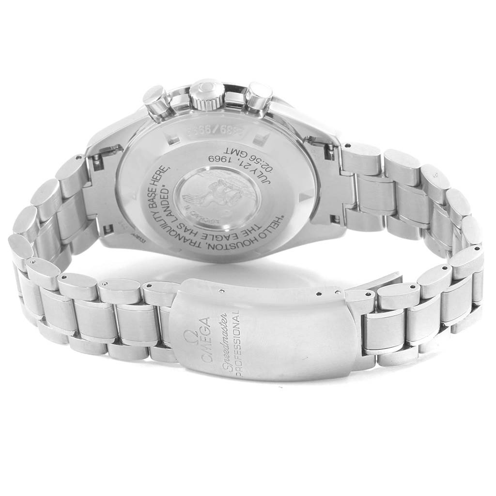 The image shows the back and clasp of the Omega Speedmaster 3560.50.00 Men
s Stainless Steel Black Dial 3560.50.00 Men
s Stainless Steel Black Dial watch, highlighting its metal bracelet and engraved case back.