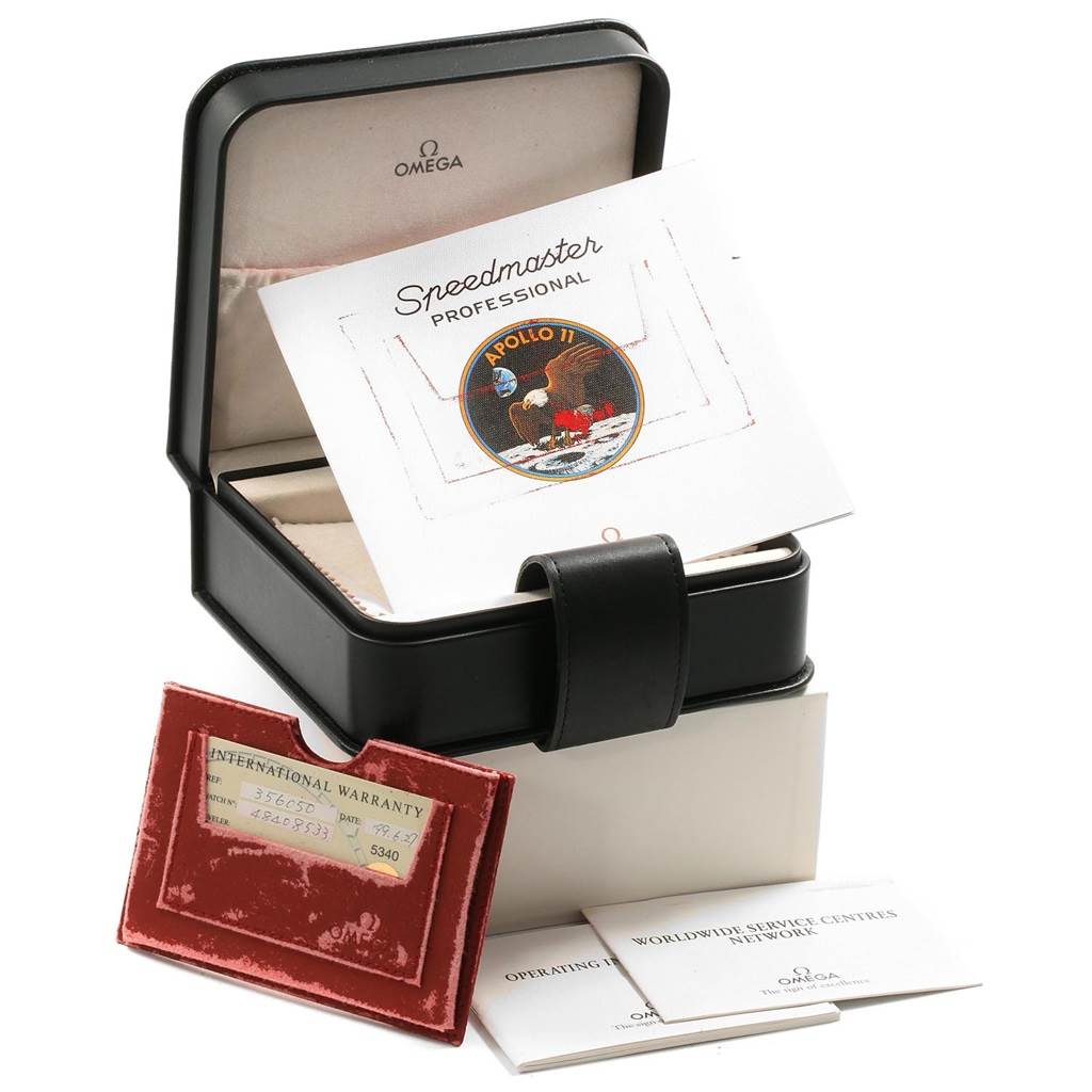 The image shows the packaging and accessories for an Omega Speedmaster 3560.50.00 Men
s Stainless Steel Black Dial 3560.50.00 Men
s Stainless Steel Black Dial, including the box, warranty card, and booklets.