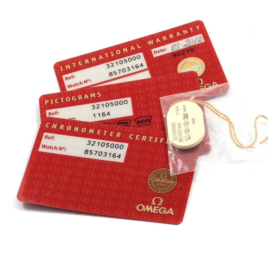 The image shows international warranty and chronometer certificate cards, along with a tag for the Omega Speedmaster 3210.50.00 Men
s Stainless Steel Black Dial 3210.50.00 Men
s Stainless Steel Black Dial watch.