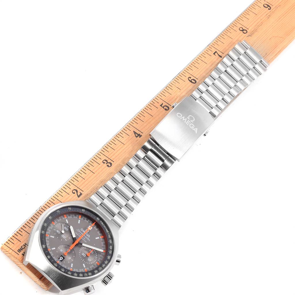 The watch is an Omega Speedmaster 327.10.43.50.06.001 Men
s Stainless Steel Grey Dial 327.10.43.50.06.001 Men
s Stainless Steel Grey Dial, shown from the dial to the bracelet, with a wooden ruler for size reference.