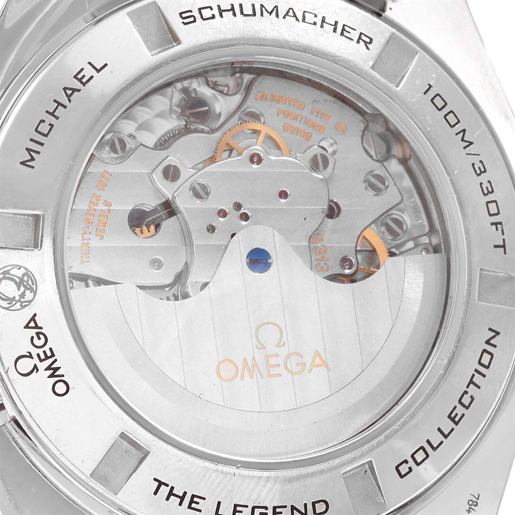 The image shows the back view of an Omega Speedmaster 321.30.44.50.01.001 Men
s Stainless Steel Black Dial 321.30.44.50.01.001 Men
s Stainless Steel Black Dial watch, showcasing its mechanical movement and "Michael Schumacher" engraving.