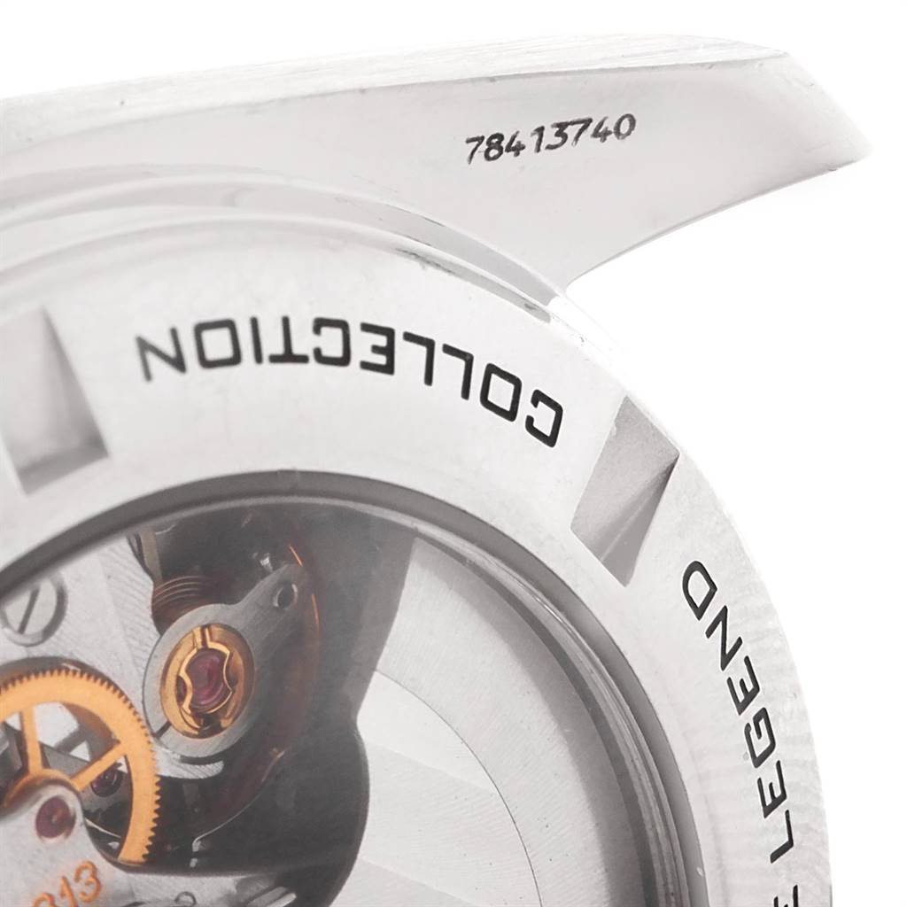 The image shows a close-up of the case back of an Omega Speedmaster 321.30.44.50.01.001 Men
s Stainless Steel Black Dial 321.30.44.50.01.001 Men
s Stainless Steel Black Dial watch, revealing part of its internal mechanism and inscriptions.