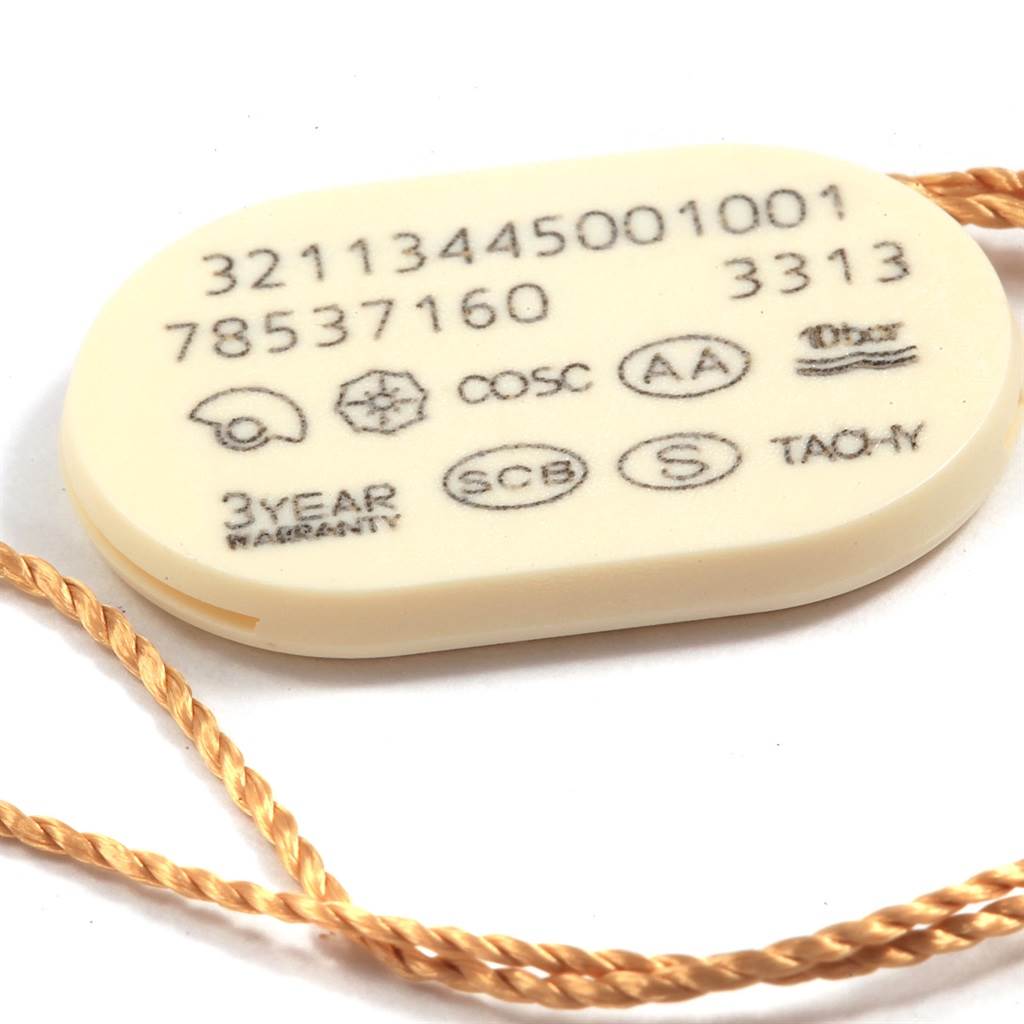 The image shows a close-up of a hang tag for an Omega Speedmaster 321.13.44.50.01.001 Men
s Stainless Steel Black Dial 321.13.44.50.01.001 Men
s Stainless Steel Black Dial watch, displaying serial numbers and certification markers.