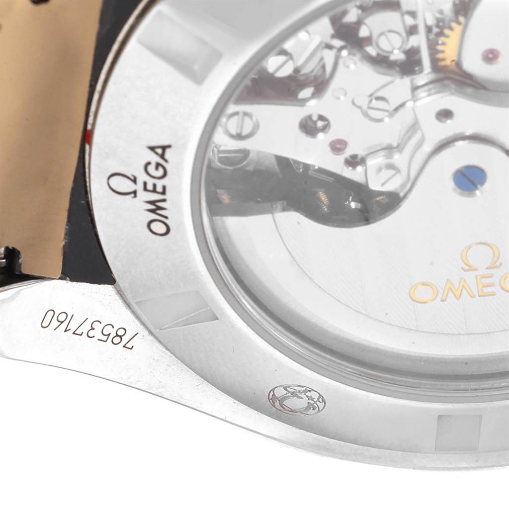 The image shows a close-up of the Omega Speedmaster 321.13.44.50.01.001 Men
s Stainless Steel Black Dial 321.13.44.50.01.001 Men
s Stainless Steel Black Dial
s back case with partial internal movement visible.