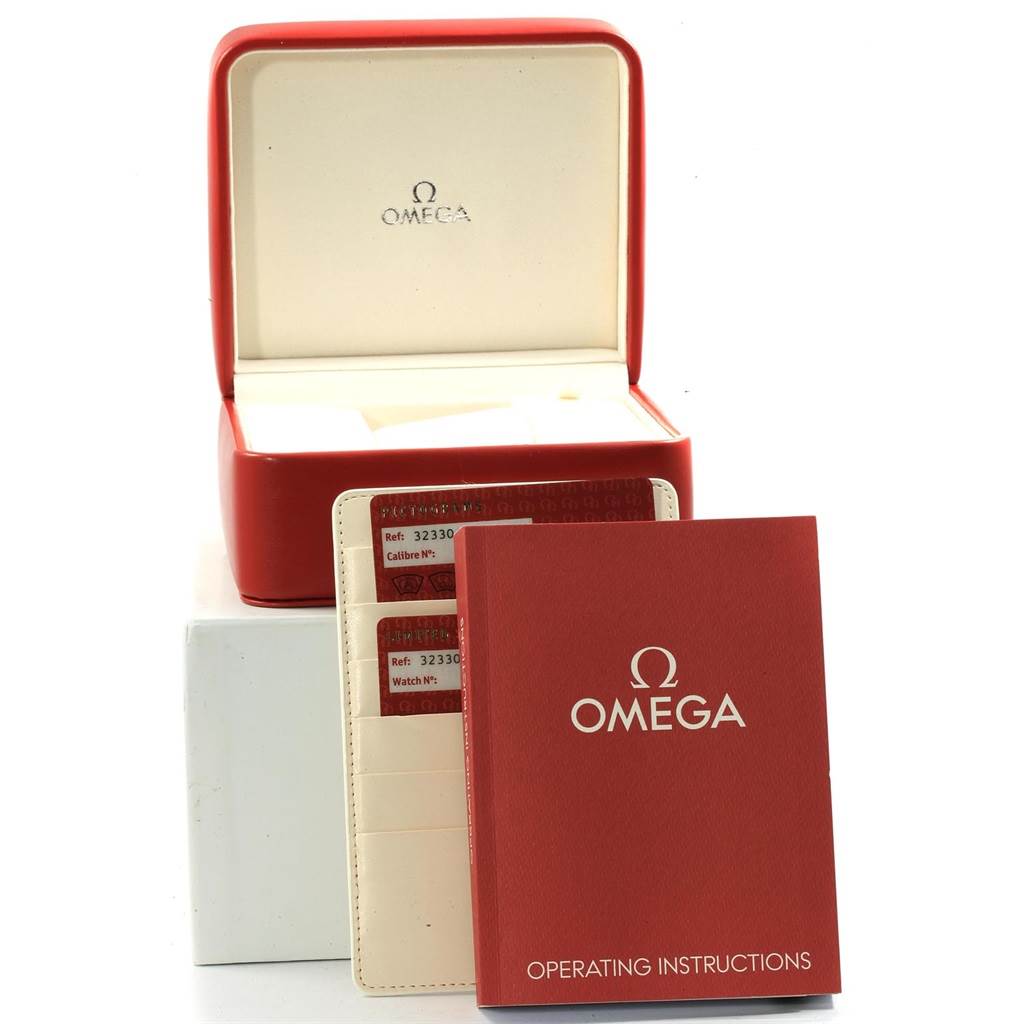 The image shows an empty Omega Speedmaster 323.30.40.40.02.001 Men's Stainless Steel White Dial 323.30.40.40.02.001 Men's Stainless Steel White Dial watch box, instruction manual, and warranty cards from a front angle.