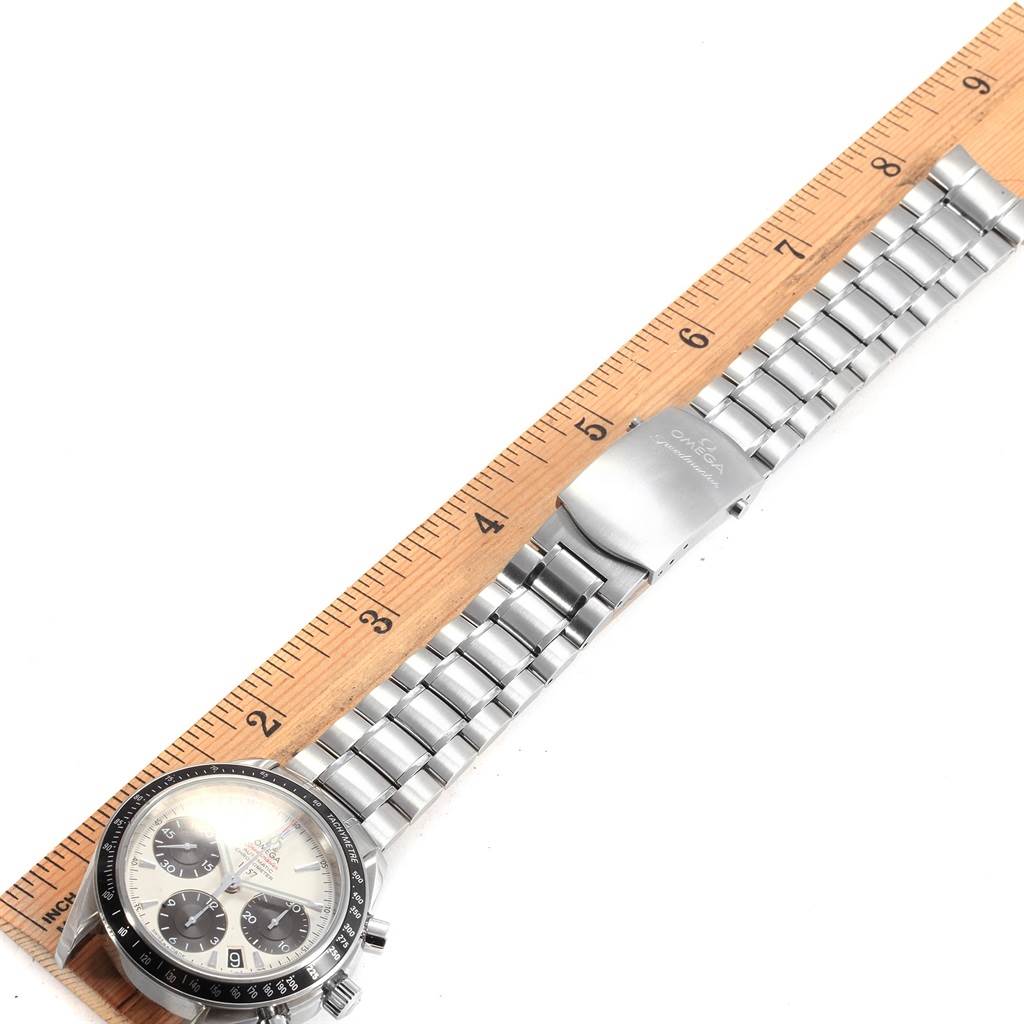 The image shows an Omega Speedmaster 323.30.40.40.02.001 Men's Stainless Steel White Dial 323.30.40.40.02.001 Men's Stainless Steel White Dial watch placed beside a ruler, highlighting its full bracelet and clasp.